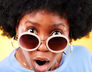 Image showing Surprise, black woman and shock on face with sunglasses, fashion and crazy sale, deal or offer in studio background. Confused, portrait and African person with shocked, wow or emoji for promotion