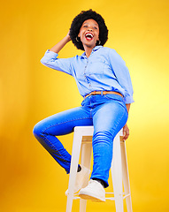 Image showing Black woman, smile and portrait on a chair in studio, yellow background or natural happiness with casual fashion and style. African, gen z or model relax with laugh for creative, mockup or space