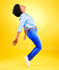 Image showing Dance, balance and woman on tiptoe in studio with fun energy, positive attitude or action. Profile of African model person isolated on yellow background as freedom, belief and faith or casual fashion