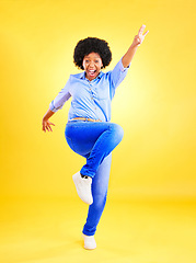 Image showing Excited, happy and a woman in studio with fun energy, positive attitude and action. Portrait of African model person isolated on yellow background for freedom dance, winner or celebration of success