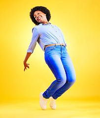 Image showing Excited, happy and a woman tiptoe in studio with fun energy, positive attitude and action. Portrait of African model person isolated on yellow background for freedom dance, winner or celebration