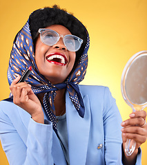 Image showing Vintage, woman laughing and makeup with mirror and retro clothing apply red lipstick and confidence. Female model, studio and yellow background with cosmetics, fashion accessories and trendy glasses