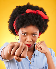 Image showing Strong, fist and boxing with portrait of black woman in studio for power, motivation and energy. Empowerment, pride and champion with person on yellow background for challenge, punch and hard work