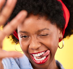 Image showing Portrait, black woman or influencer taking a selfie with a crazy face or tongue out on social media. Fashion, funny wink or cool African girl taking a photo, vlog or picture on studio background