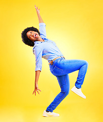 Image showing Excited, crazy and a woman in studio with fun energy, positive attitude and balance. Happy African model person isolated on yellow background for freedom dance, winner or wow celebration of success