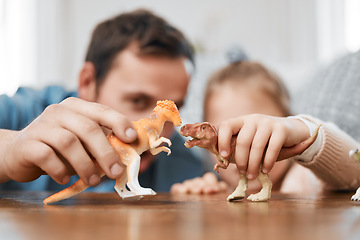 Image showing Playing, dinosaur and the hands of a father and child for bonding, childhood and on a table. Closeup, together and a man, dad or kid with a toy for happiness, entertainment or family in a house