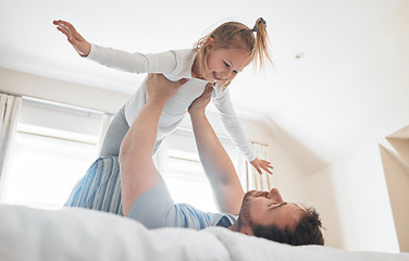 Image showing Girl, father and happy on bed for airplane games, energy and relax for crazy fun at home. Dad, child and excited to fly in bedroom for freedom, fantasy and lift to balance for play, trust and support