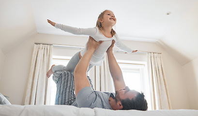 Image showing Child, dad and happy on bed for airplane games, support and relax for crazy fun in house. Father, girl kid and excited to fly in bedroom for freedom, fantasy and balance for play, trust and energy