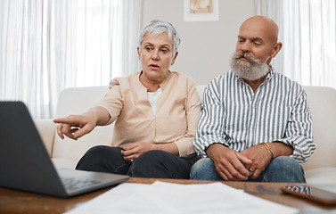 Image showing Budget, finance and senior couple with laptop planning financial investments, mortgage or tax papers. Elderly woman apeaking of bills, debt and pension fund on bank statement with an old man at home