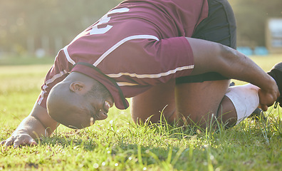 Image showing Sports, field injury and a black man during soccer with an emergency in fitness or training. Grass, pain and an African football player or athlete on the ground during a game with an accident