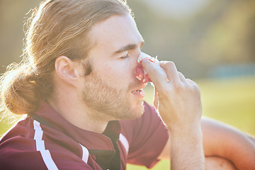 Image showing Nose bleed, man closeup and sports injury closeup on field with emergency, health accident and blood outdoor. Swollen, broken and male athlete with medical and pain or bruise after game and exercise
