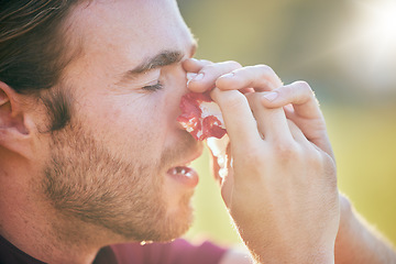 Image showing Nose bleed, man and injury closeup on sport field with emergency, accident and blood outdoor. Swollen, broken and male athlete with medical and bruise after pain, game workout and exercise training