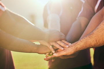 Image showing Hands, sports and a rugby team in huddle together for a game or goal of competition in a stadium closeup. Fitness, teamwork and flare with an athlete group standing in circle for solidarity or unity