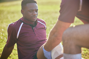 Image showing First aid, sport injury and black man with soccer accident, fitness and massage on a field. Training, workout and physical therapy of knee pain at game with healthcare emergency from exercise
