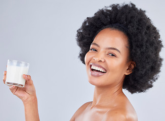 Image showing Woman, portrait and milk glass in studio for healthy diet, detox or calcium on white background. Happy african model, dairy drink or smoothie of vanilla milkshake for nutrition, weight loss or beauty