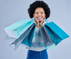 Image showing Portrait, woman and shopping bag on studio background for fashion, happy retail deal and financial freedom. Excited african customer, gift and discount present from boutique, store or sales promotion