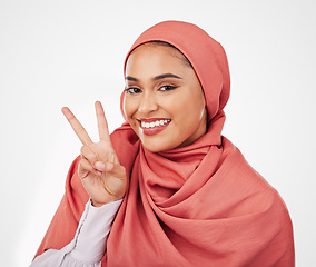 Image showing Peace sign, smile and muslim with portrait of woman in studio for support, kindness and motivation. Happy, emoji and wellness with face of person on white background for excited and v hand gesture