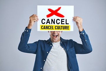 Image showing Cancel culture, man and protest sign in hand with message for social media violence and support in studio. Banner, person and mouth with mockup space for solidarity and opinion on grey background