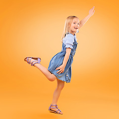 Image showing Portrait, girl and kid with a smile, fly or fantasy with joy, happiness or excited on a yellow studio background. Person, model or child with power, hero game or imagine with energy, happy or playful