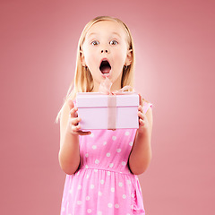 Image showing Present, gift and wow portrait of a child in studio for birthday, holiday or happy celebration. Excited girl on a pink background with ribbon, mouth open and amazing surprise giveaway prize in box