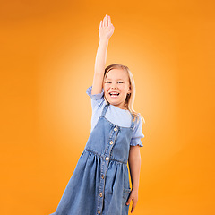 Image showing Portrait, hands raised and happy kid with question in studio isolated on an orange background mockup space. Excited, answer and girl child asking why, learning student and education at kindergarten