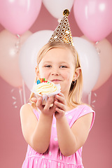 Image showing Balloons, birthday and portrait of child with cupcake for holiday, happy celebration and fun party. Young girl kid on a pink background for surprise, cake or celebrate achievement with a dessert