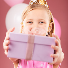 Image showing Birthday, gift and portrait of a child with balloons in studio for party, holiday or happy celebration. Face of excited girl kid on a pink background giving box, present or surprise package in hands