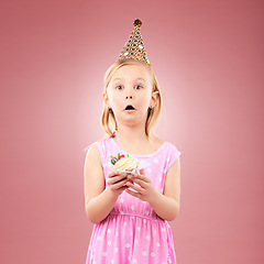 Image showing Portrait, surprise and kid with cupcake at birthday in studio isolated on a pink background mockup space. Face, wow of child and cake at party in hat at celebration, food event and shocked at dessert