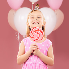 Image showing Balloons, lollipop and portrait of girl on pink background for birthday party, celebration and special day. Happy, excited and young cute child smile with candy, sweet treats and dessert in studio