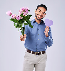 Image showing Roses, portrait and asian man with purple heart in studio for thank you, gift or care on white background. Paper, frame and Japanese male model with flower, bouquet or offer, love or valentines day