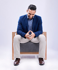 Image showing Smile, professional and businessman on a chair in a studio with confidence, confidence and law career. Happy, advisor and young male attorney from Mexico sitting on sofa to relax by white background.