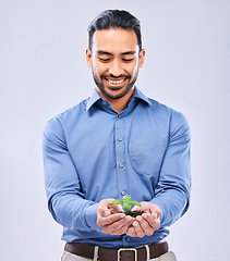 Image showing Development, sustainability and businessman happy with growth isolated in a studio white background with plant. Palm, startup and entrepreneur with soil and plant as an investment or climate change