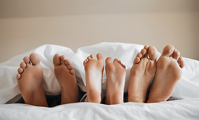 Image showing Feet, parents and kid sleeping on bed to relax with love, rest or sleeping on hotel mattress in morning. People, hospitality and bedroom for child, mother and father for bonding, care or family house