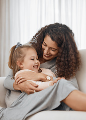 Image showing Love, hug and mother with girl child on a sofa happy, playing and bonding in their home together. Family, smile and kid with mom in a living room embrace, relax and enjoy weekend, day off or break