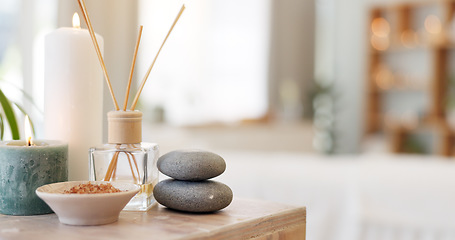 Image showing Spa, rock and candle to relax in a room with atmosphere, mood or ambience in a health club. Wellness, luxury and treatment with still life objects on a table in a clinic for rest and relaxation