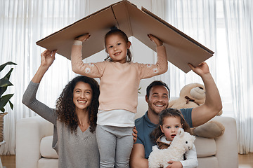 Image showing Parents, kids and cardboard roof in portrait, smile or excited for security, property investment or insurance in family home. Mother, father and children with box, happy and together with new house