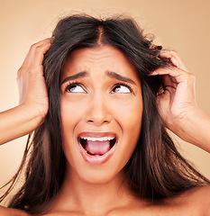 Image showing Woman, hair care fail and stress in studio, shouting and thinking for solution by beige background. Girl, model and split end with mistake, frustrated and cosmetics for beauty, aesthetic or wellness