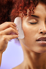 Image showing Skincare, face and woman with gua sha in studio for facelift, wellness or anti aging on purple background. Beauty, crystal and lady model relax with facial, massage or lymphatic drainage for collagen