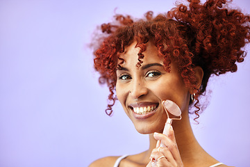 Image showing Cosmetics, portrait and happy woman with rose quartz roller for massage, facial lymphatic drainage or skin routine. Stone product, mockup advertising space and studio girl on purple background