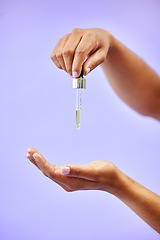 Image showing Skincare, hands and woman with oil in studio for wellness, dermatology or skin glow on purple background. Beauty, female and lady model show liquid serum for self care, shine or cosmetic collagen