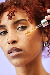 Image showing Skincare, portrait and woman with facial serum in a studio for natural, beauty and cosmetic routine. Self care, health and female model from Colombia with face oil for hydration by purple background.