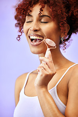 Image showing Skincare, rose quartz and woman in studio for wellness, anti aging or collagen circulation on purple background. Crystal, beauty and lady model with jade roller facial, massage or lymphatic drainage