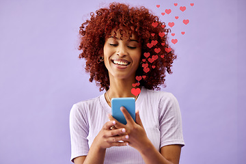 Image showing Happy woman with phone, social media and like emoji in studio to love, subscribe and review on post. Smile, face and influencer on purple background with notification icon opinion on cellphone app.