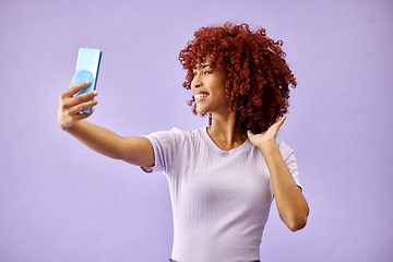 Image showing Smile, selfie and curly hair of woman in studio isolated on a purple background mockup space. Happy, photography and profile picture of person for fashion, style and social media post on internet