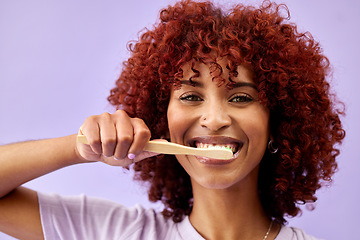 Image showing Face, smile and woman brushing teeth with wood in studio isolated on purple background. Portrait, bamboo toothbrush and happy person cleaning for eco friendly hygiene, dental health or sustainability