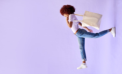 Image showing Fashion, shopping and a woman walking on mockup in studio on a purple background for advertising. Retail, commerce and orientation with a young customer carrying bags on banner space for marketing