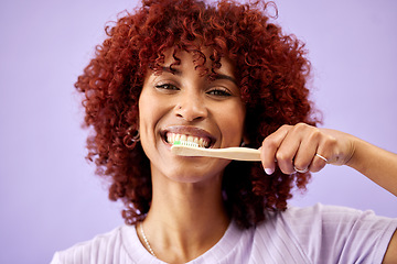 Image showing Face, smile and woman brushing teeth with bamboo in studio isolated on purple background. Portrait, wood toothbrush and happy person cleaning for eco friendly hygiene, dental health or sustainability