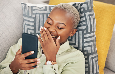 Image showing Black woman on sofa with phone, laughing and meme on social media, message or video online. Happy face, smile and internet, girl on couch with digital app on smartphone and funny viral post in home.