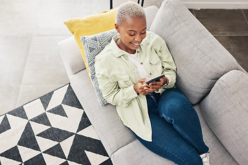 Image showing Woman, relax and typing with phone on sofa for social media, chat and online contact at home from above. Happy african person, smartphone and download mobile games, digital multimedia and dating app