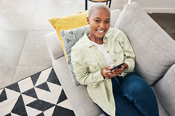 Image showing Woman, portrait and relax with phone on couch for social media, text chat and contact at home from above. Happy african person, smartphone and download mobile games, digital multimedia and dating app